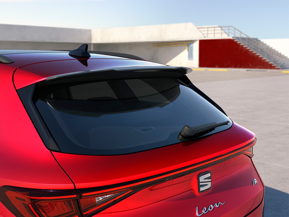 Ein Mann betrachtet den Dachspoiler des SEAT Leon in Cosmo Grey
