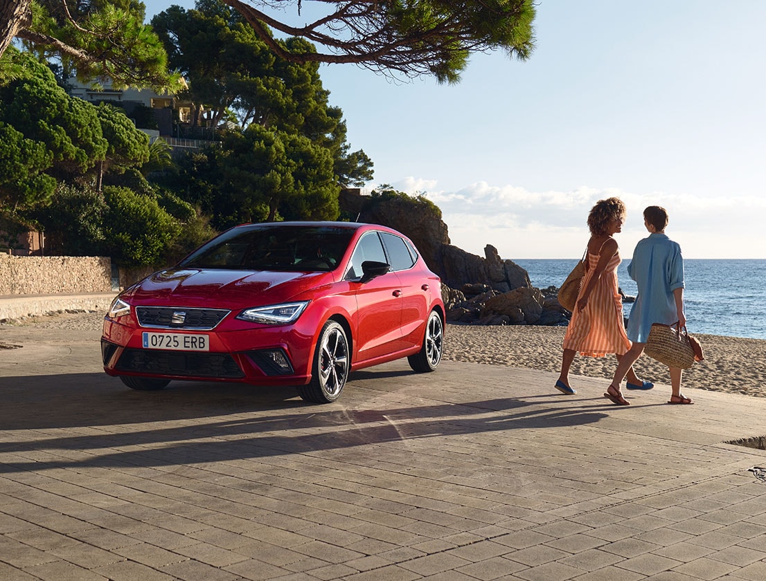 woman talking on the phone with the seat ibiza on the background